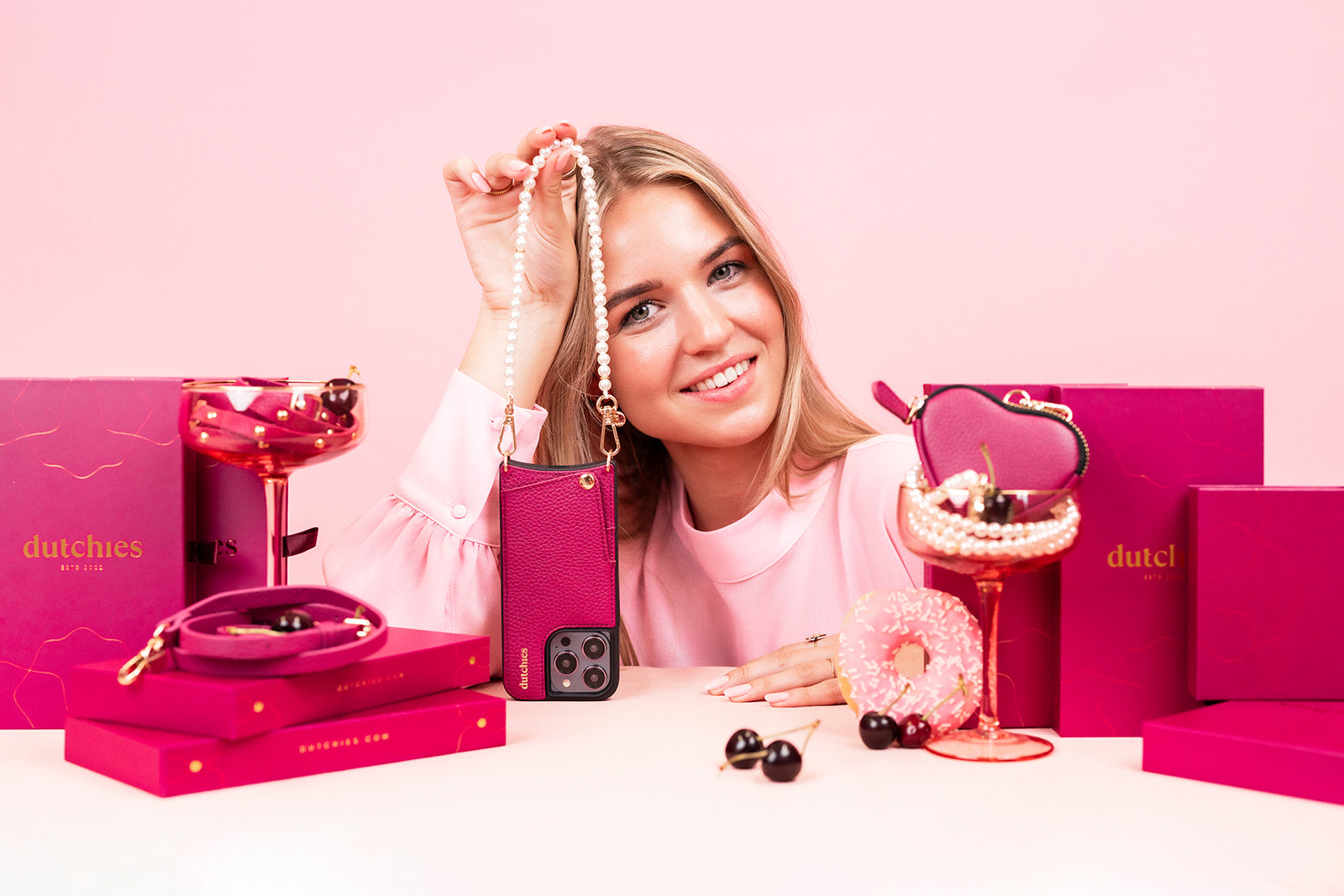 Model showcasing stylish accessories from the Ruby Collection with pink packaging and playful elements.