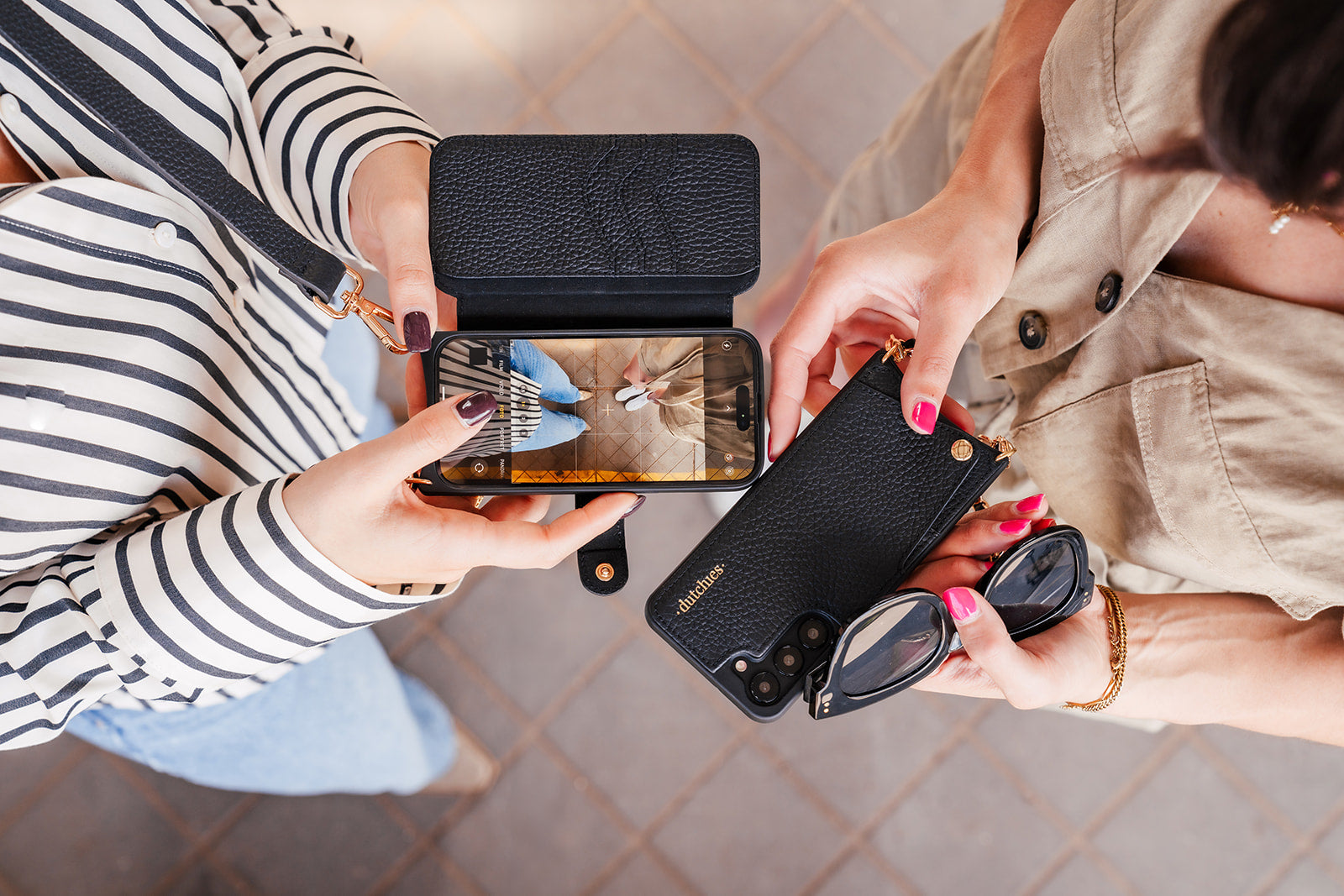 Samsung Wallet Case held by two people showcasing style and functionality with a smartphone and accessories.