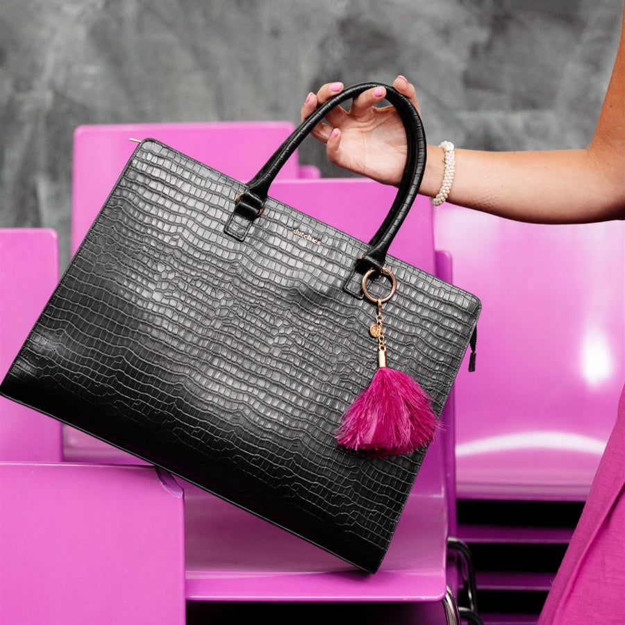Vavavoom | Keychain attached to a chic black handbag, adding a splash of color and flair to your stylish look.