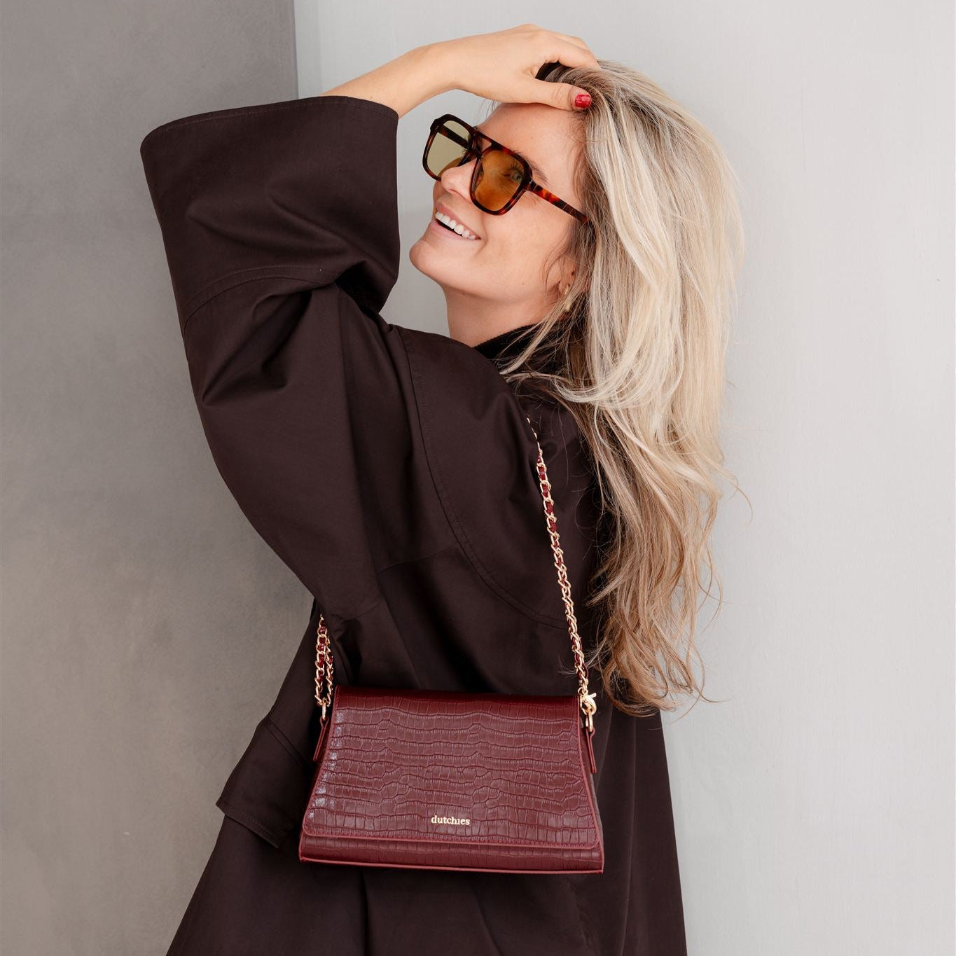 Sophie Crossbody Bag | Burgundy worn stylishly, showcasing its elegance and practicality with a stunning model.