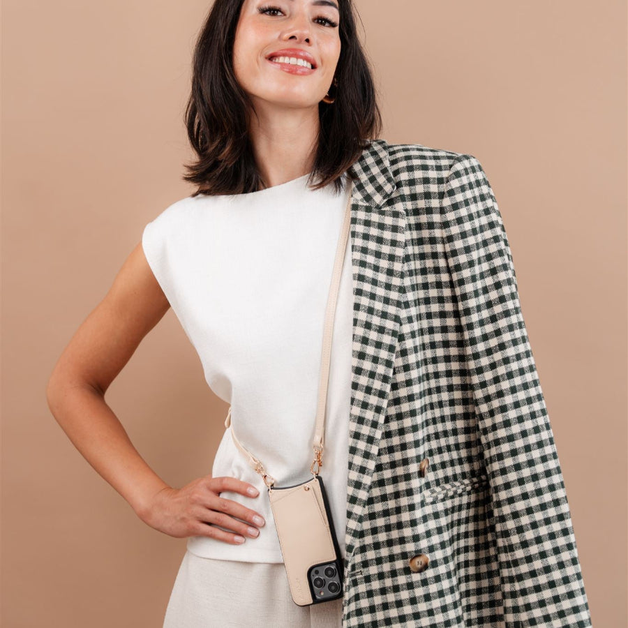 Model showcasing iPhone Case | Vanilla with stylish outfit and plaid blazer, emphasizing fashion and functionality.