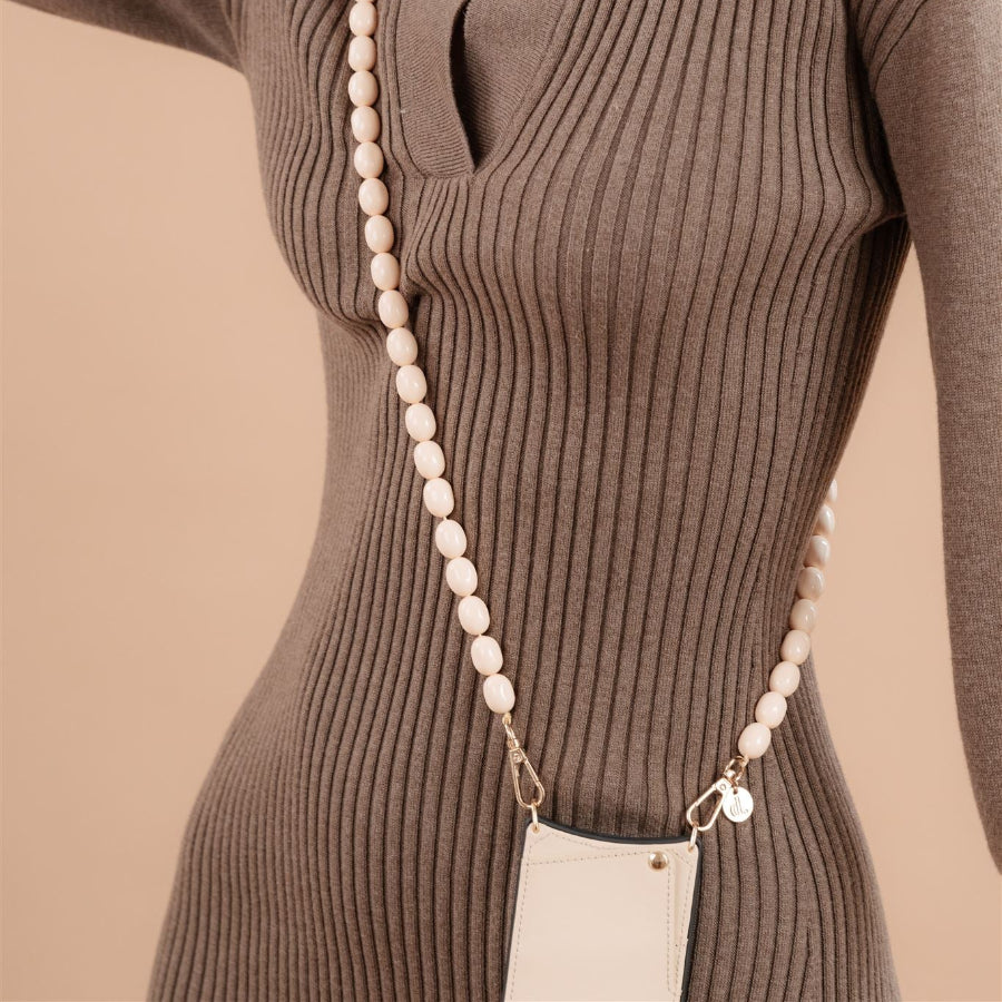 Beaded phone chain Gwen worn with a ribbed brown dress, showcasing style and functionality.