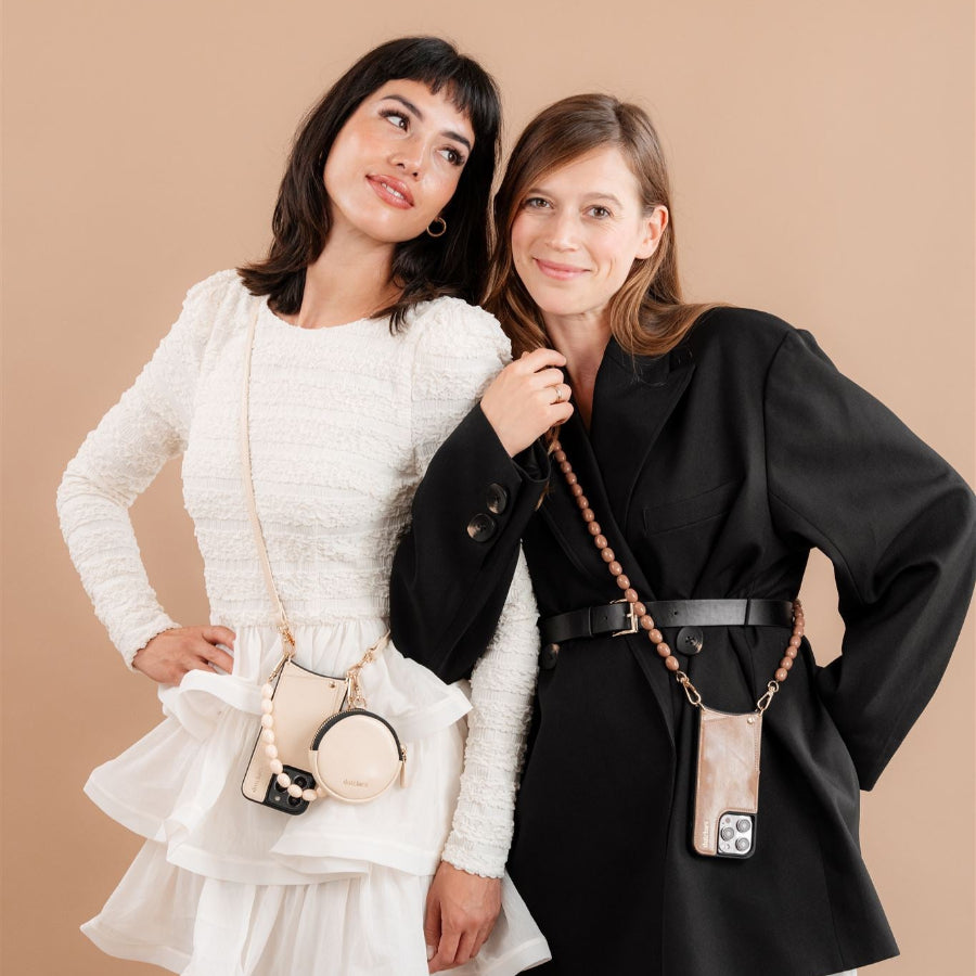 Two stylish women showcasing beaded phone chains against a beige background, representing modern fashion accessories.