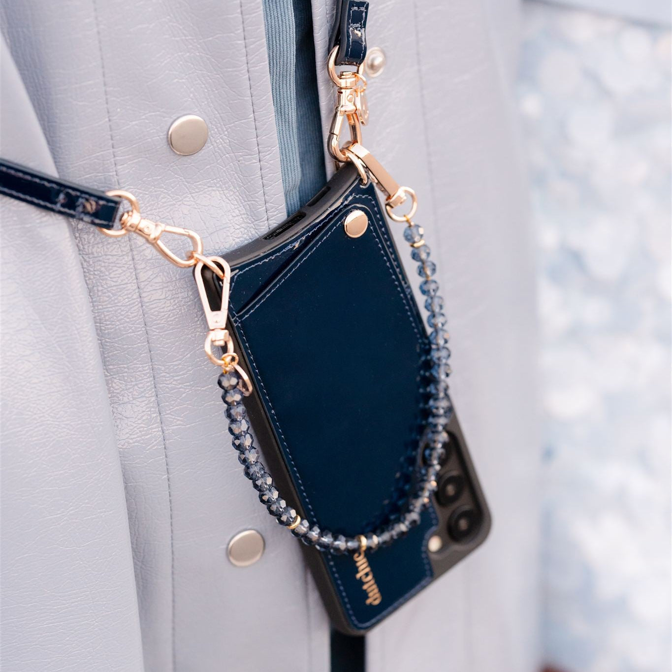 Phone Charm | Beaded | Grace with shiny blue pearls attached to a stylish phone case.