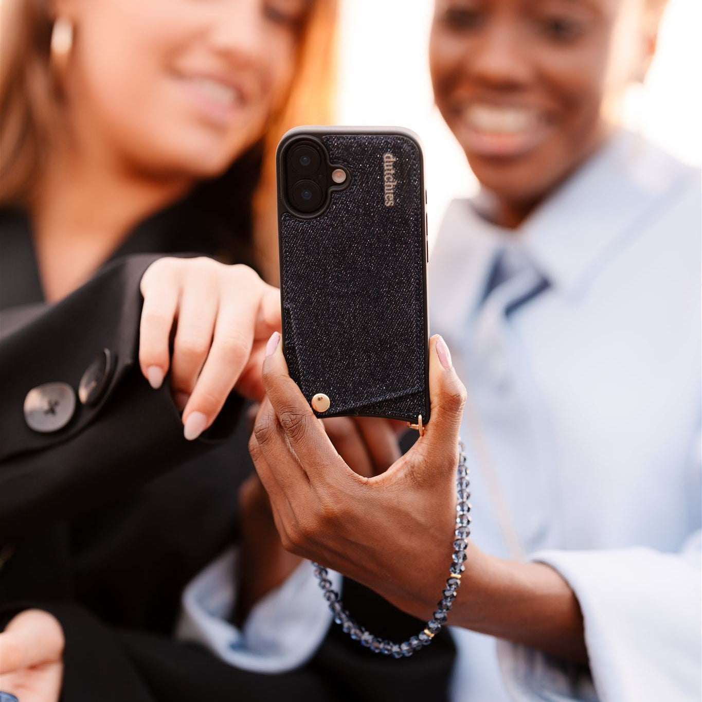 Phone Charm | Beaded | Grace with a stunning beaded design, held by two smiling friends in a fashionable setting.