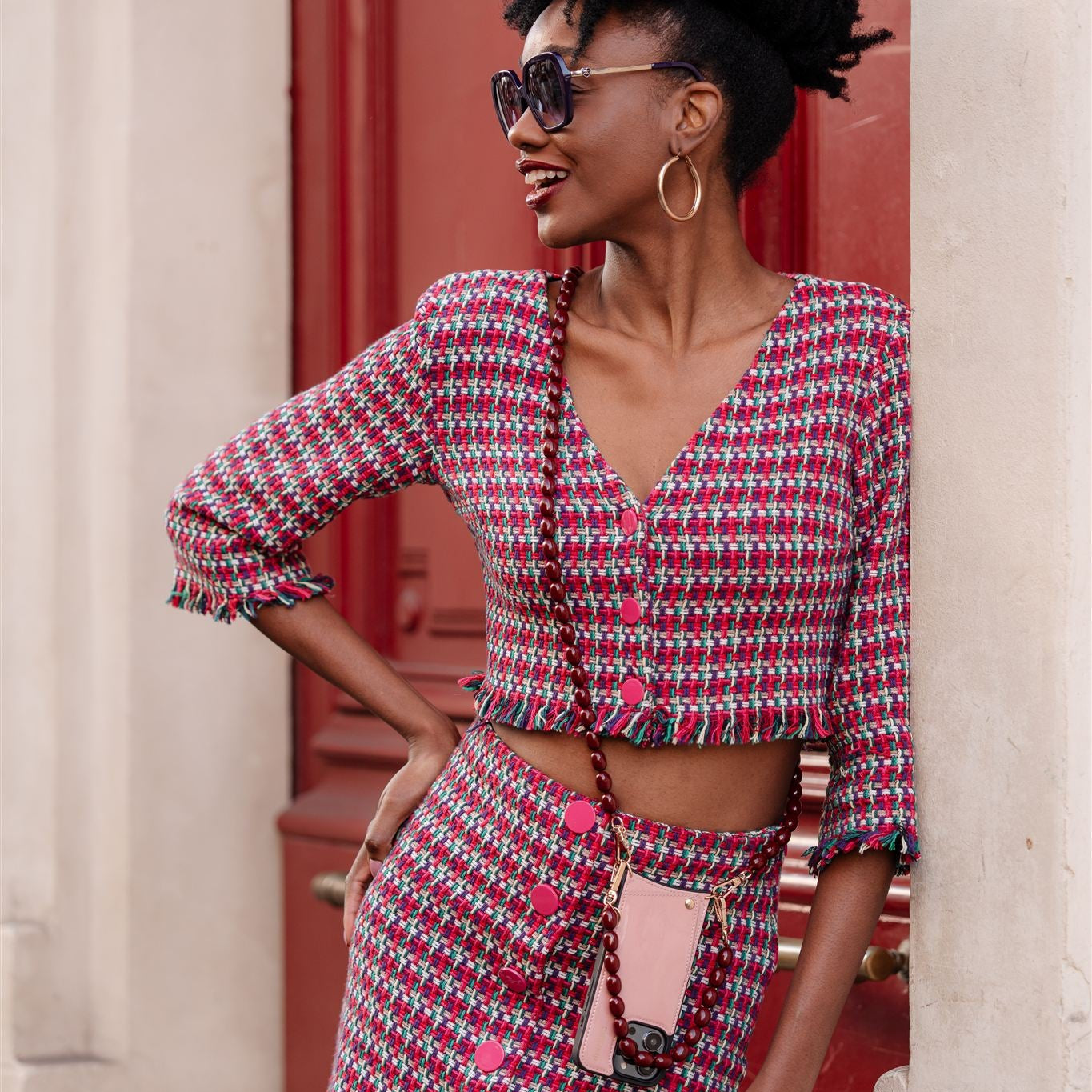 Beaded Phone Chain | Charley styled with a trendy outfit featuring a cropped blazer and matching skirt.