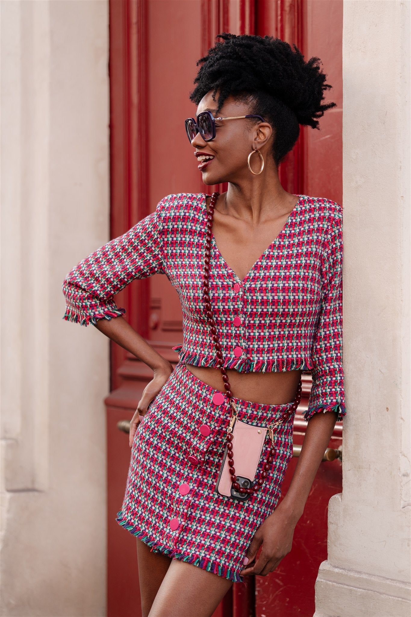 Beaded Phone Chain | Charley styled with a trendy outfit featuring a cropped blazer and matching skirt.
