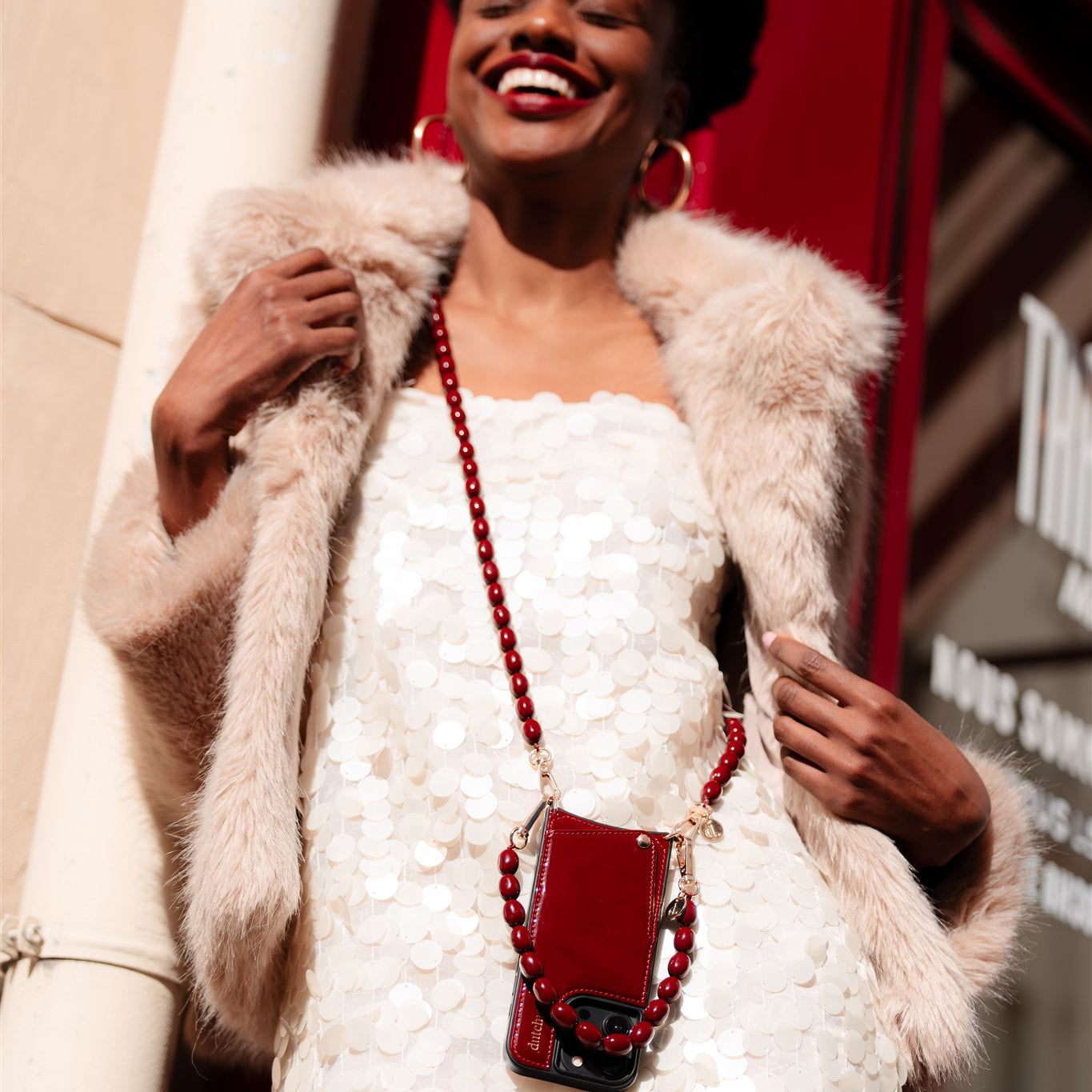 Beaded Phone Chain | Charley stylishly worn on a model with a burgundy phone case and chain, exuding elegance.