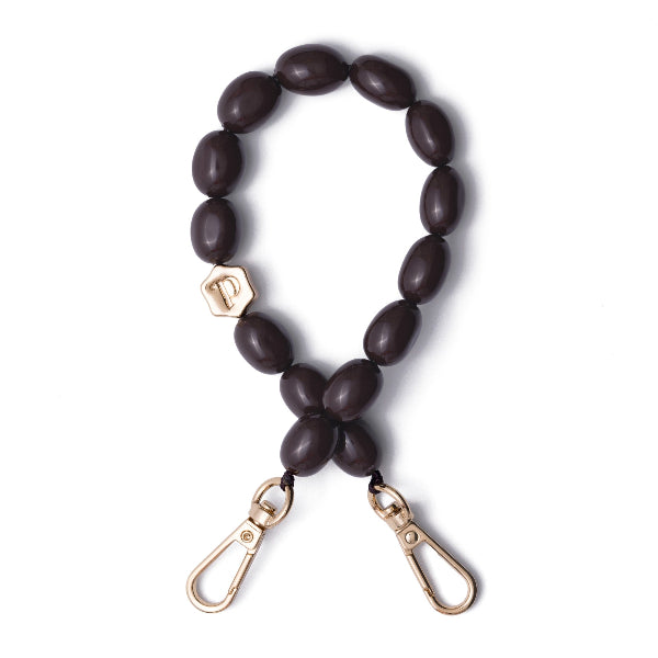 Beaded drak brown phone charm with gold carabiners on a white background