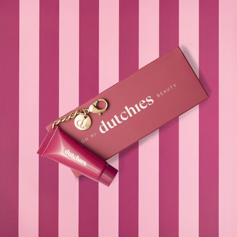 Body Cream Glitter | Keychain on a stylish striped background with a chic keychain and packaging.