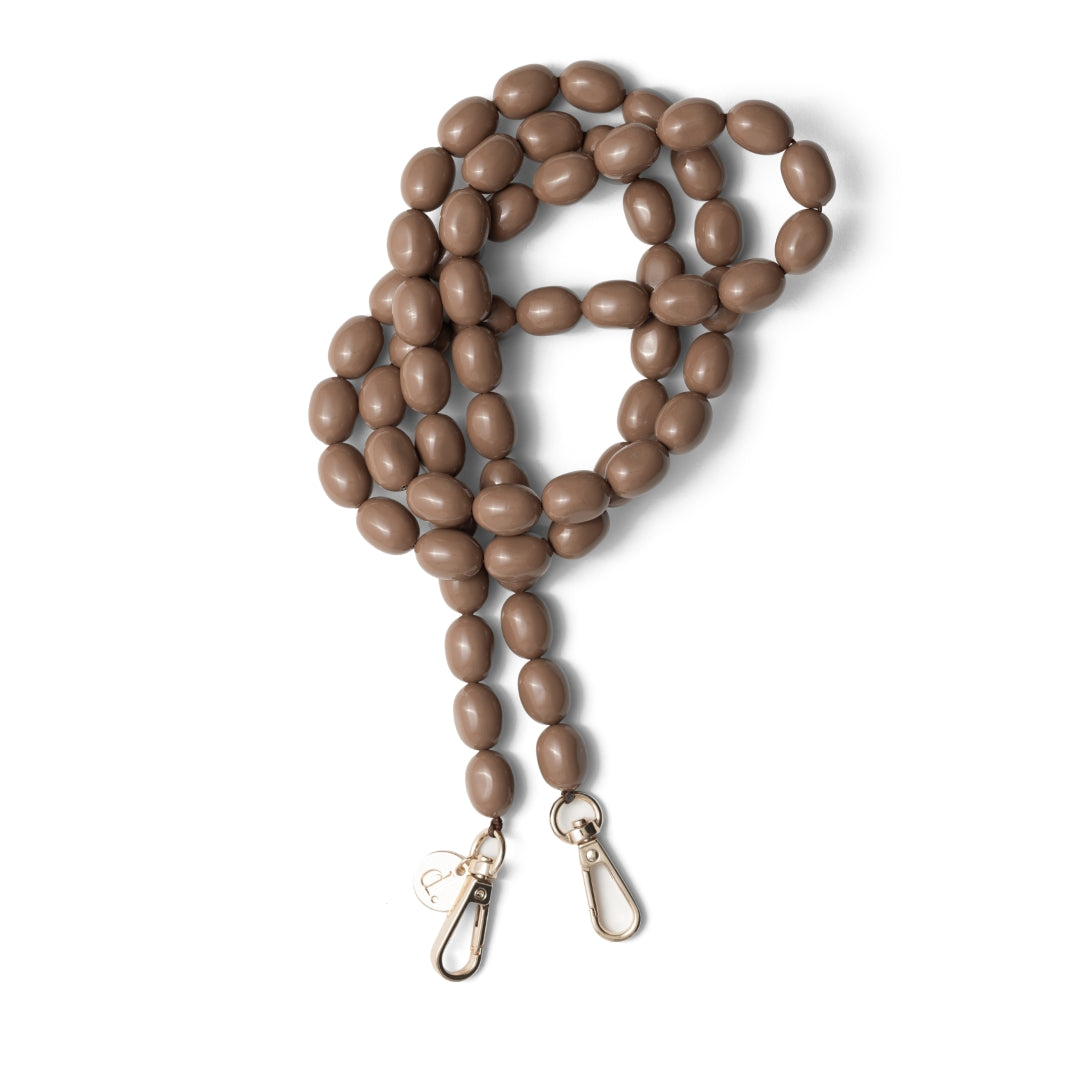 Brown beaded phone chain inspired by artist Rachel Ruysch, featuring oval beads and metal clasps.