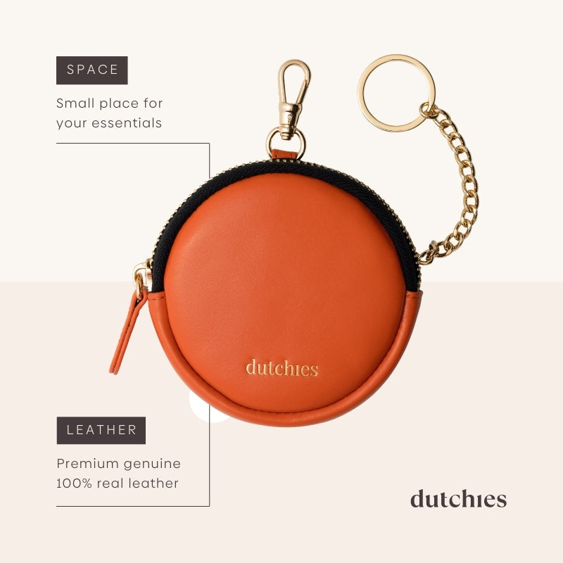 Mini Phone Bag Emma | Orange - Round orange leather pouch for essentials with keychain.