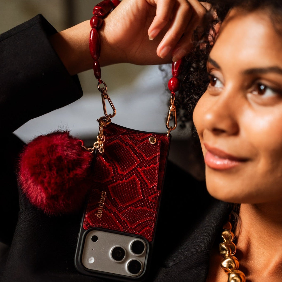 Charm Set | iPhone | Snake Red | Stevie showcased on a woman's hand with a stylish phone charm and case.