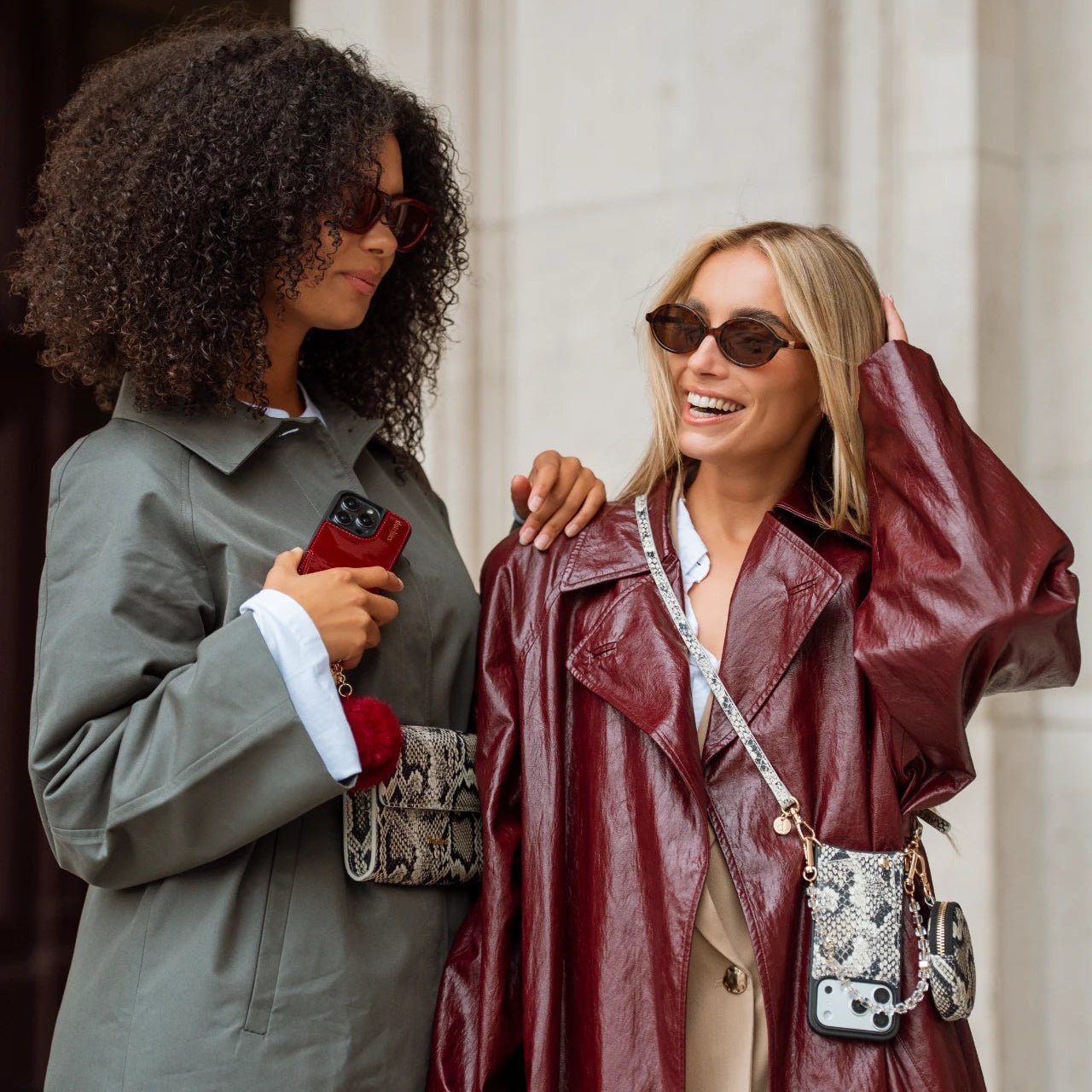 Stylish women wearing sunglasses and phone charms, showcasing trendy phone accessories with elegance.