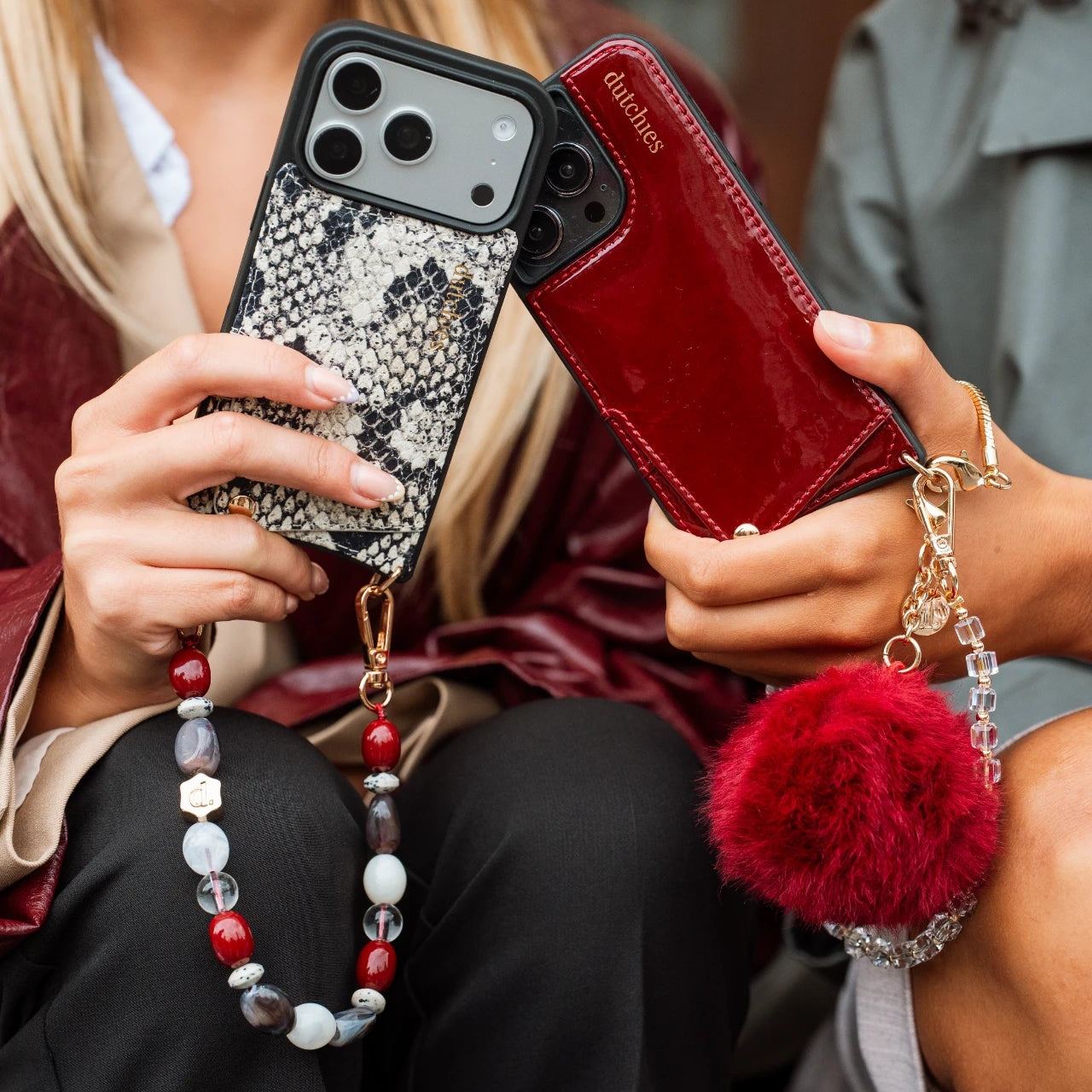 Phone Charm | Beaded | Mae showcased on stylish phone cases with vibrant glass beads and a trendy pom-pom embellishment.