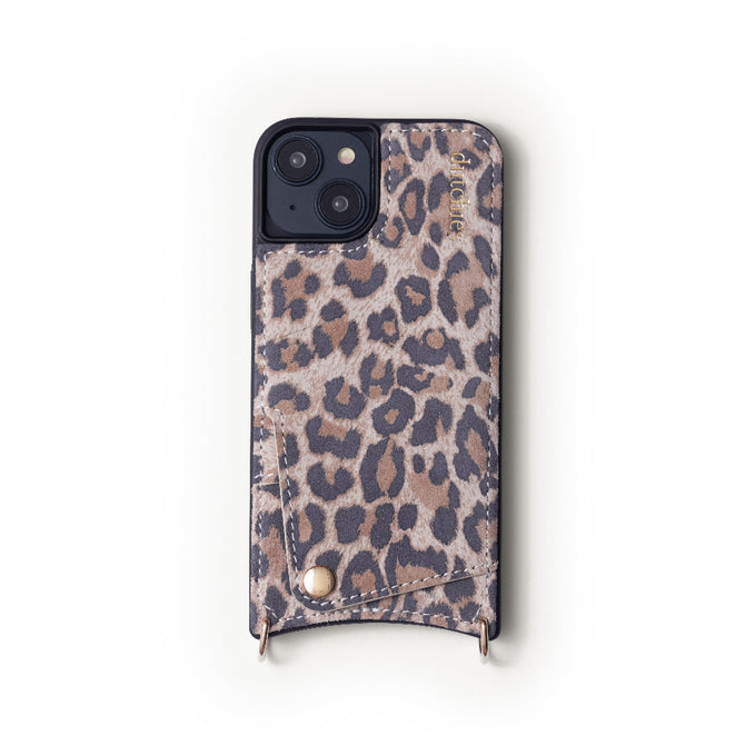 A brown animal patterned iPhone case with a leather finish and metal rings attached to the sides.