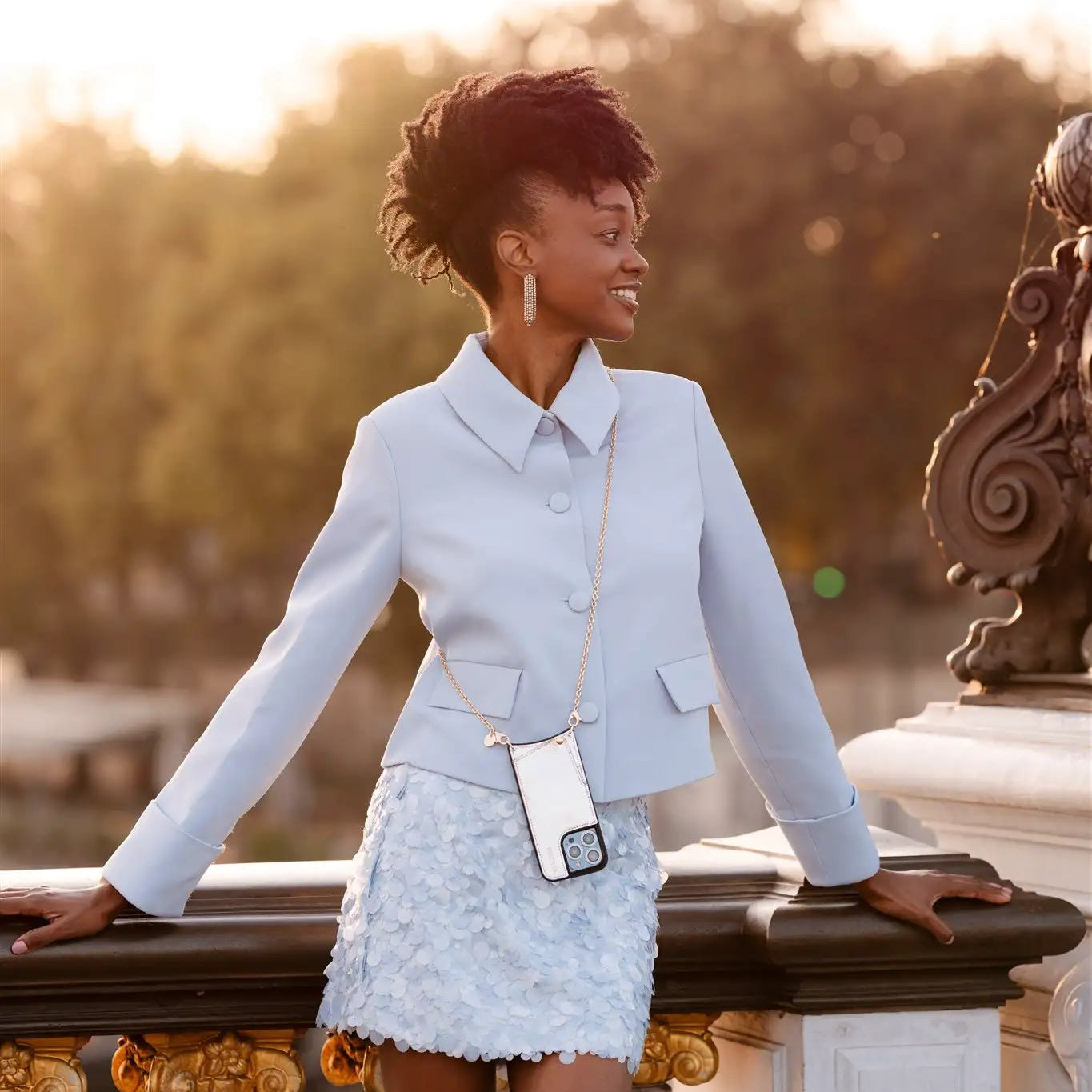 Spanish chain set | iPhone | Silvy showcased by a model in a stylish outfit, featuring a chic phone strap.