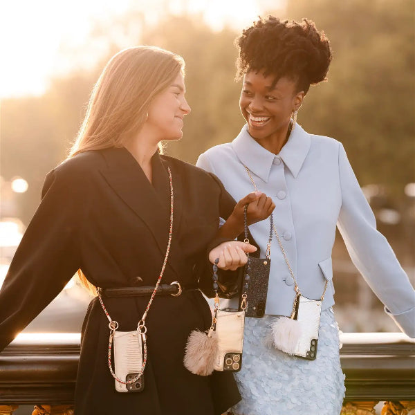 Two women enjoying the outdoors, showcasing the Spanish Chain Set | Samsung | Silvy with stylish phone cases and chains.