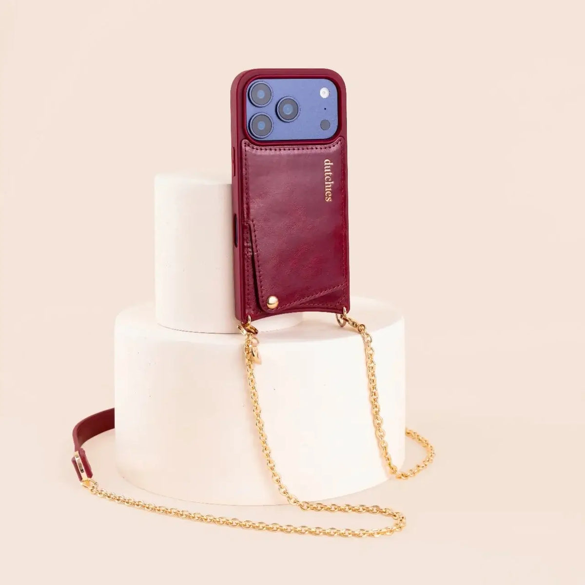 Spanish Chain Set | iPhone | Raspberry Red displayed on a pedestal with a stylish chain.