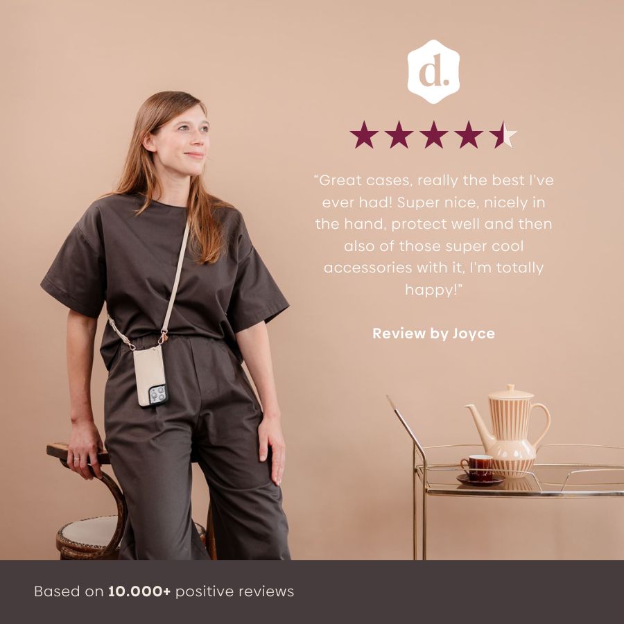 Woman showcasing iPhone Case | Vanilla, highlighting features and style with a strap, five-star review by Joyce.