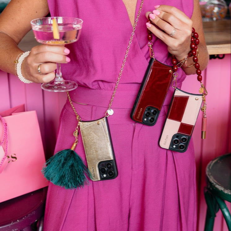 Vavavoom | Keychain showcasing colorful phone cases with cardholders and fuzzy charms, perfect for a trendy look.
