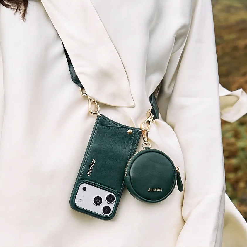 Mini Phone Bag Emma | Forest Green hanging stylishly on a white outfit, showcasing its elegant leather design.