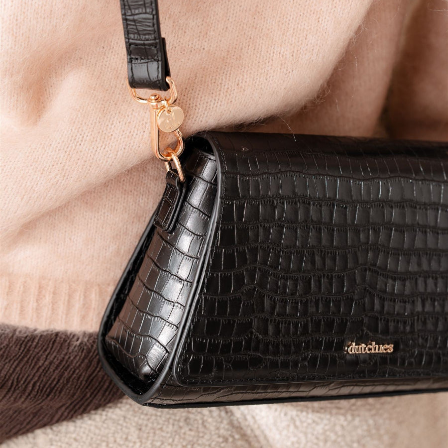 Sophie Crossbody Bag | Noir Gold, en chic telefonpose med elegante detaljer og eksklusivt håndværk i læder.
