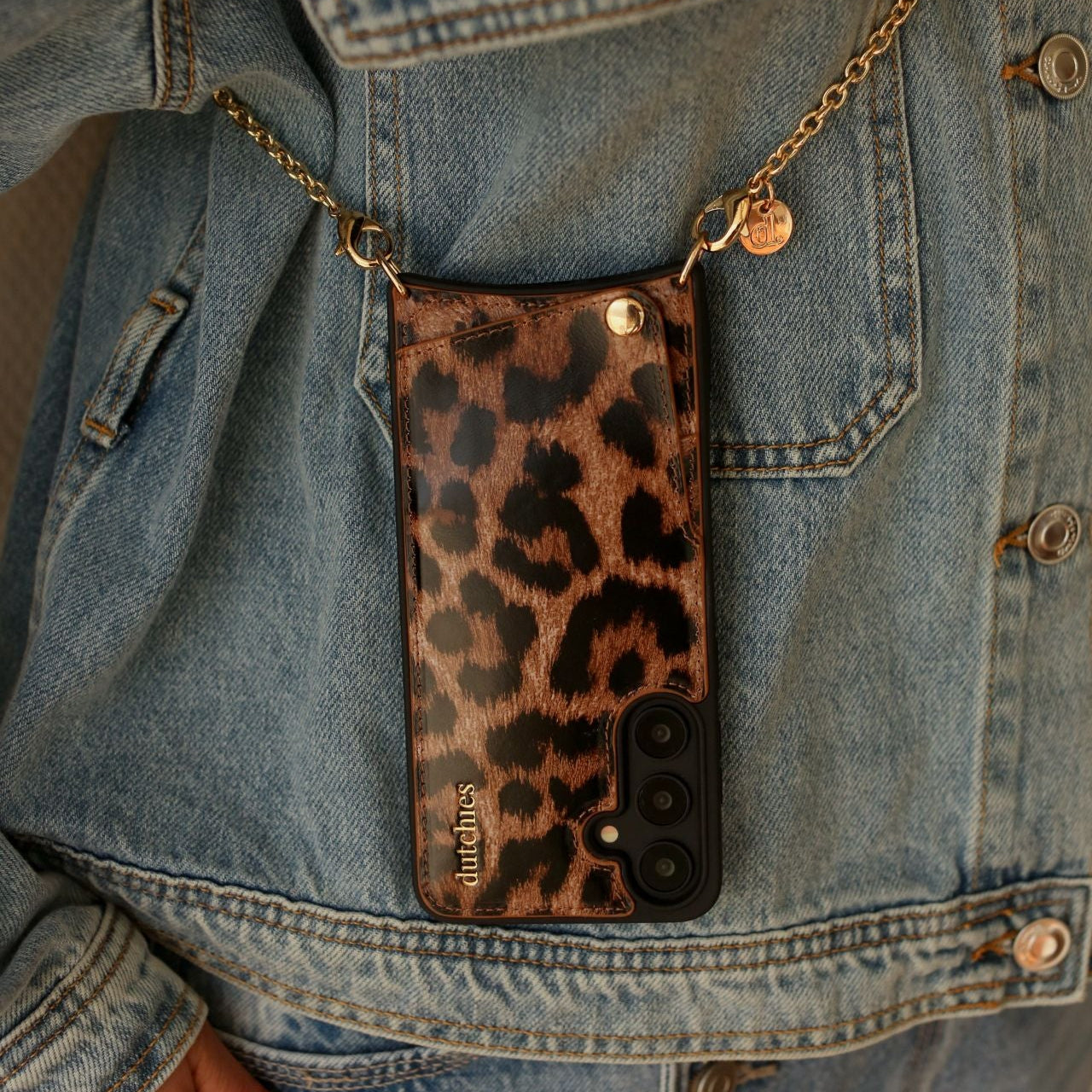 Spanish Chain Set | Samsung | Leopard with stylish leopard print case hanging from a chain on denim jacket.