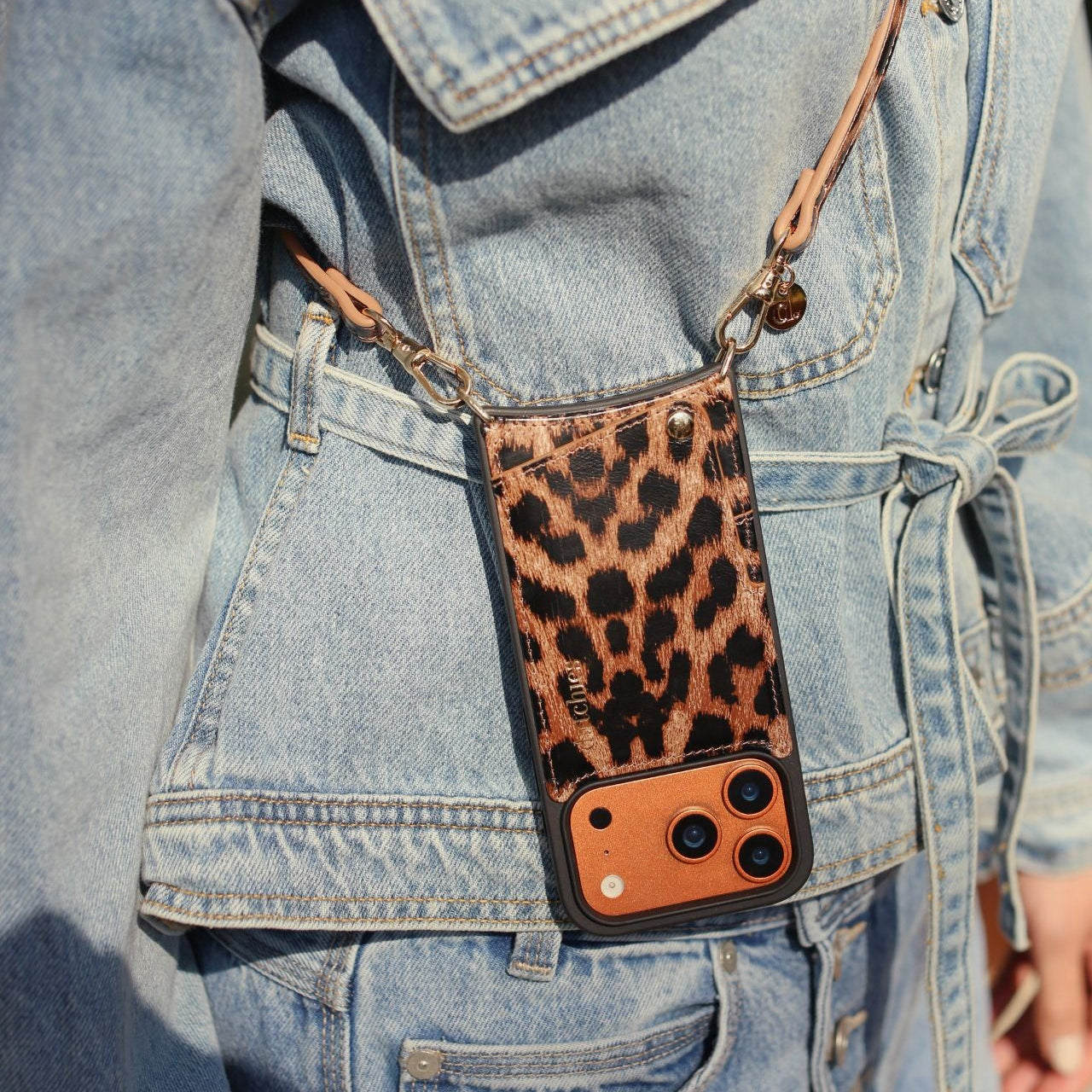 Classic set | iPhone | Leopard stylishly paired with a denim jacket, showcasing trendy phone case and slimline strap.