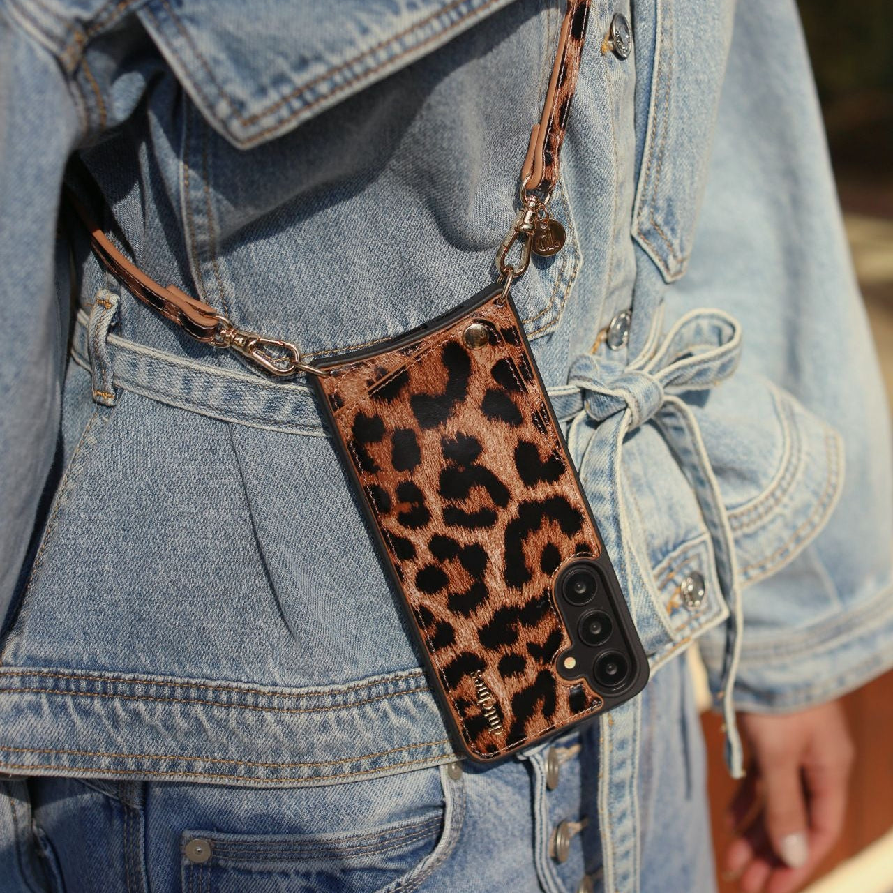Samsung Case | Leopard hanging from a stylish strap on a denim jacket, showcasing its chic leopard print design.