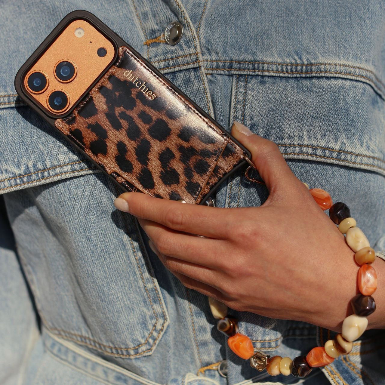 iPhone Case | Leopard in hand, showcasing stylish design, cardholder, and smartphone protection.