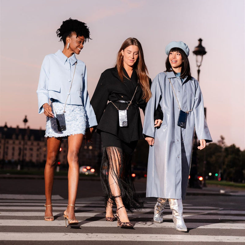 Three stylish women walking in fashionable outfits inspired by the charm of Midnight in Paris.