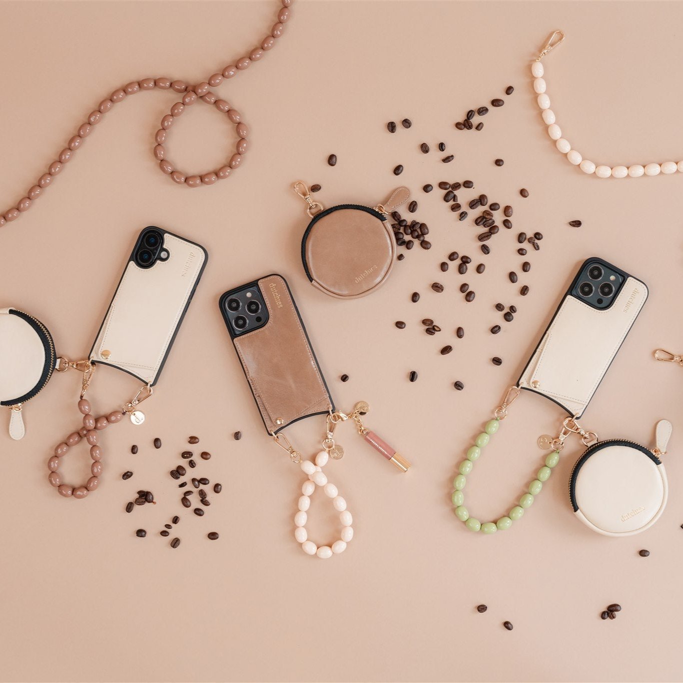 Stylish phone charms for iPhone displayed on a beige background, featuring beads and coffee beans.