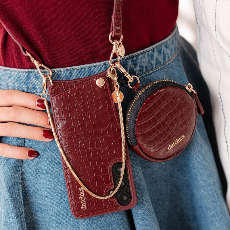 Mini Phone Bag Emma | Burgundy attached to phone case with cardholder, stylishly hanging from a denim skirt.