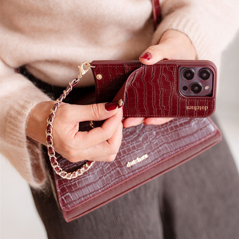 iPhone Case | Burgundy showcasing a cardholder, phone strap, and stylish design with genuine leather finish.