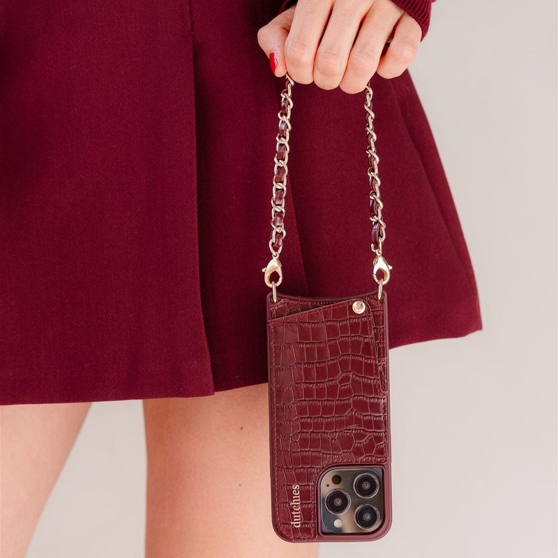 iPhone Case | Burgundy showcasing a stylish cardholder and strap, perfect for fashion-forward phone protection.
