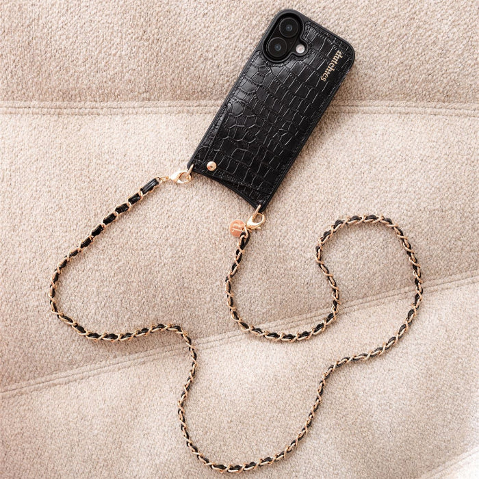 Black phone case with a chain on a beige surface