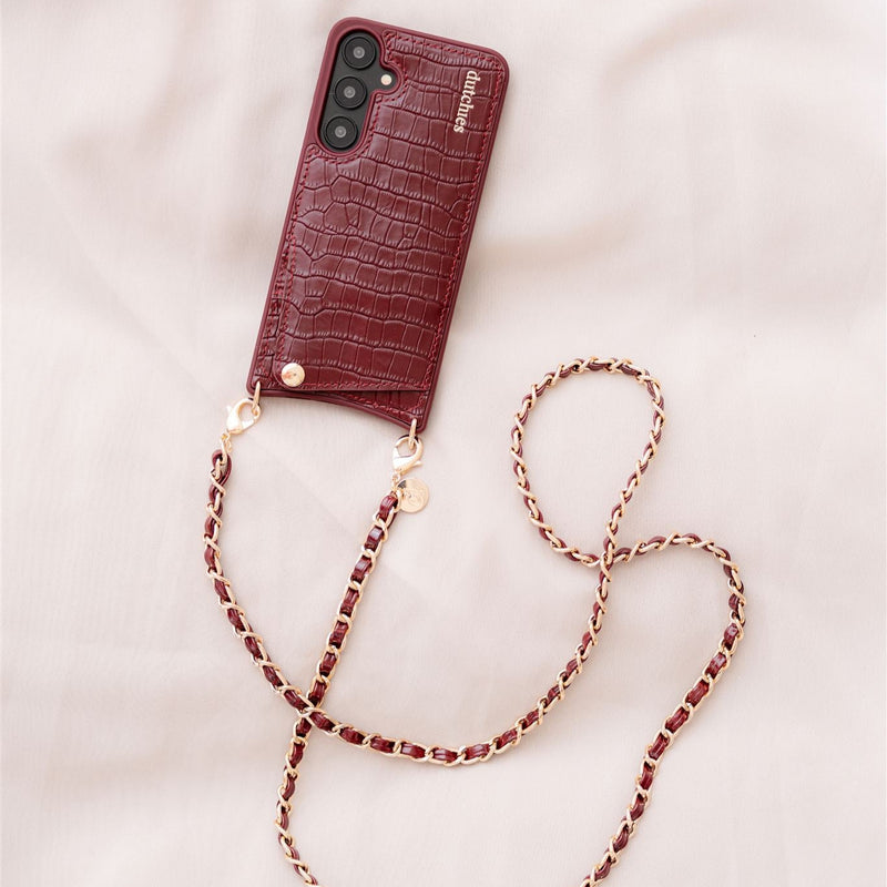 Samsung Case | Burgundy with cardholder and attached phone strap on soft background.