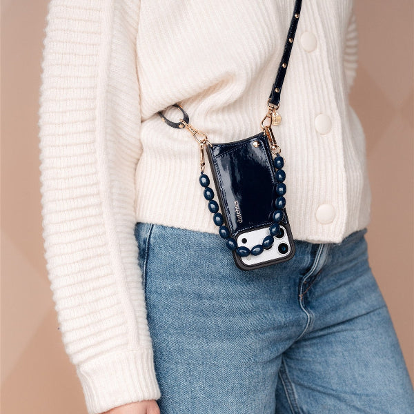 Phone Charm | Beaded | Georgia showcased on a stylish person wearing a navy sweater and denim jeans.