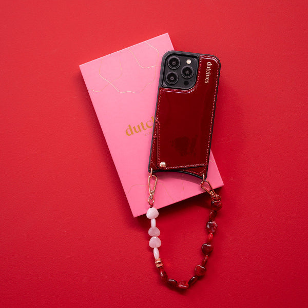 Phone Charm | Beaded | Valentina with pink hearts on a red background and Dutchies packaging.