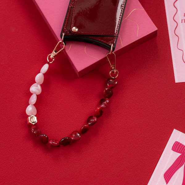 Phone Charm | Beaded | Valentina with red and pink heart beads on a red background.