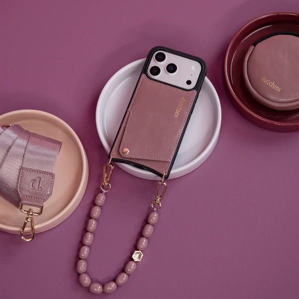 iPhone Case | Mauve lying on a plate, showcasing its leather design and cardholder feature.