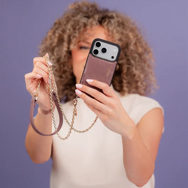 Woman holding a phone with a Phone Chain | Spanish | Mauve, showcasing trendy and practical design with hands-free convenience.