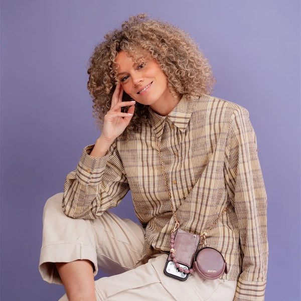 Woman wearing Phone Chain | Spanish | Mauve, showcasing a classy look with a trendy phone case.