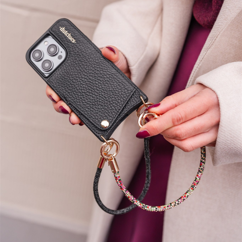 Phone Charm | Glitter | Mariah handstrap featuring a colorful design attached to a black phone case.