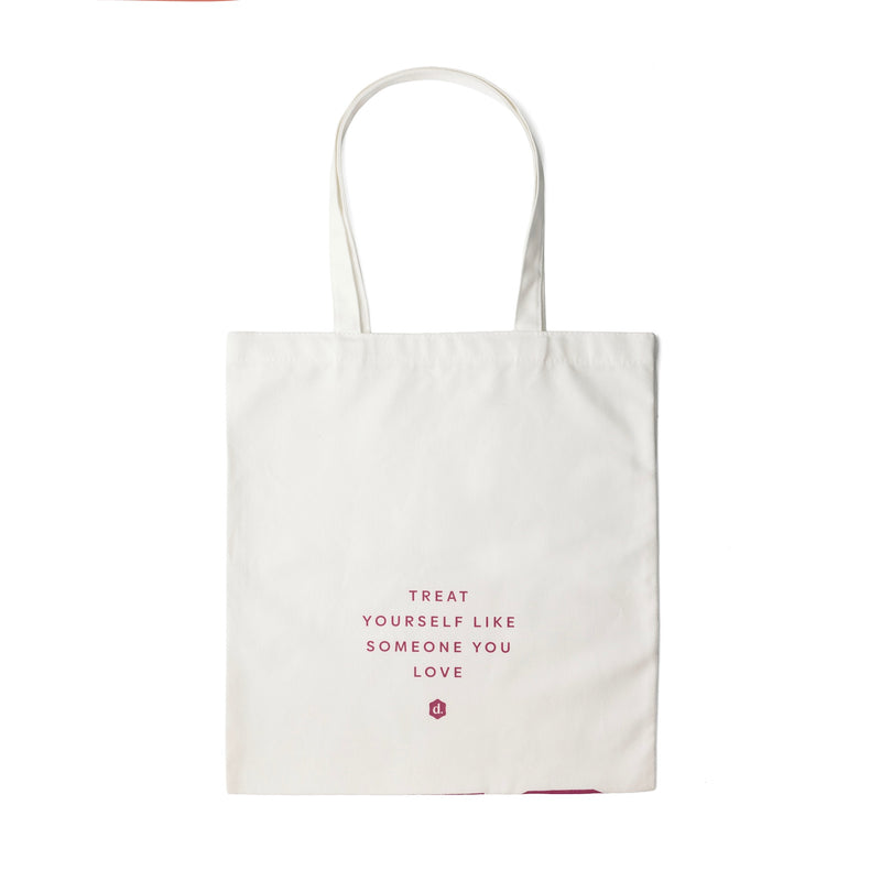 Stylish totebag with the phrase 'Treat yourself like someone you love' printed in pink.