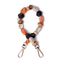 Phone Charm | Beaded | Sonia in vibrant orange and earthy tones, showcasing creativity and elegance.