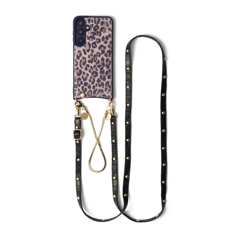 A Samsung mobile phone case with a leopard print design, accompanied by a black slimline strap with gold studs and a gold phone charm.