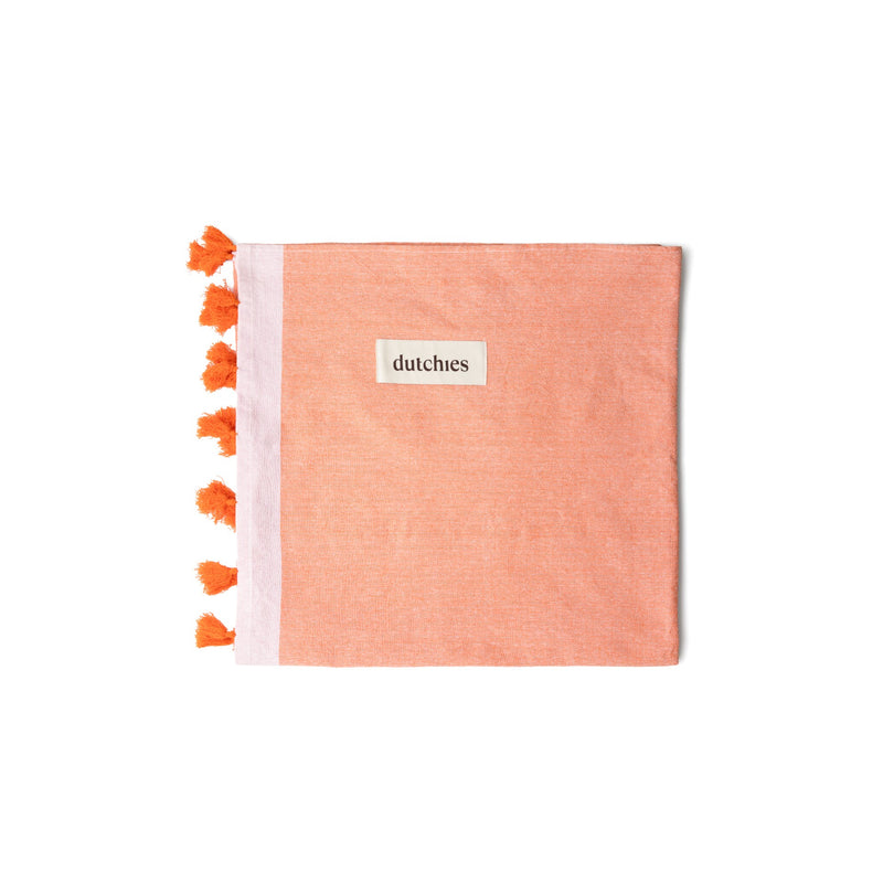 Hamam towels in vibrant orange with playful tassels, perfect for your beach bag this summer!