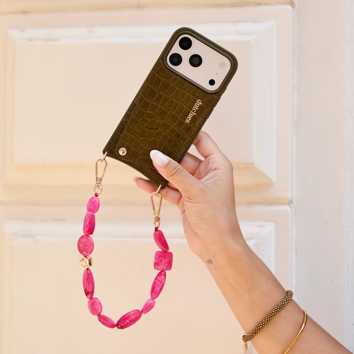 Charm Set | iPhone | Olive Green | Trudy held with pink phone charm for trendy style and convenience.